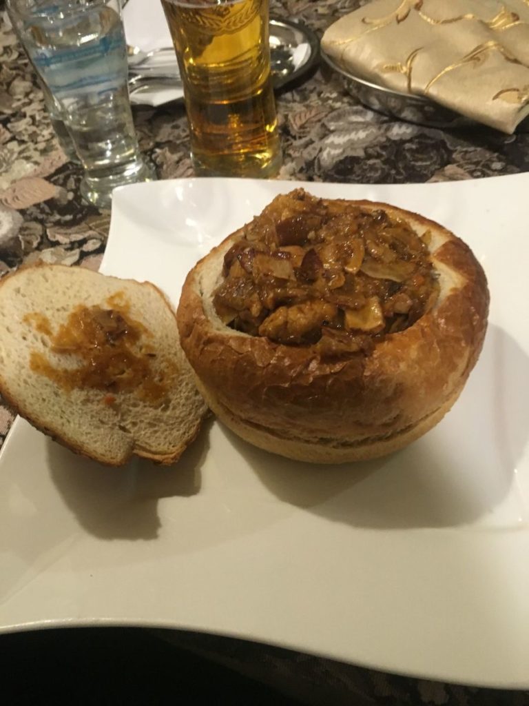 Polish bigos in a bread bowl